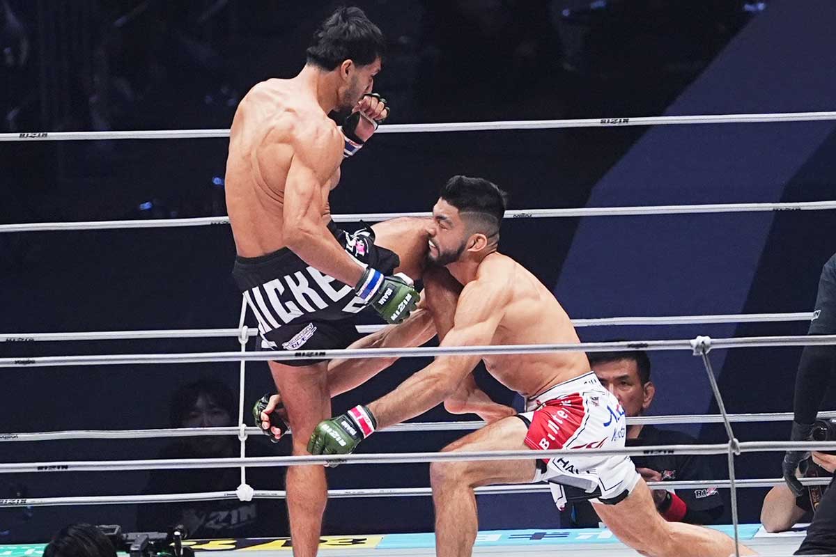 カウンターの膝蹴りを被弾したサトシ(右)【写真:小林靖】