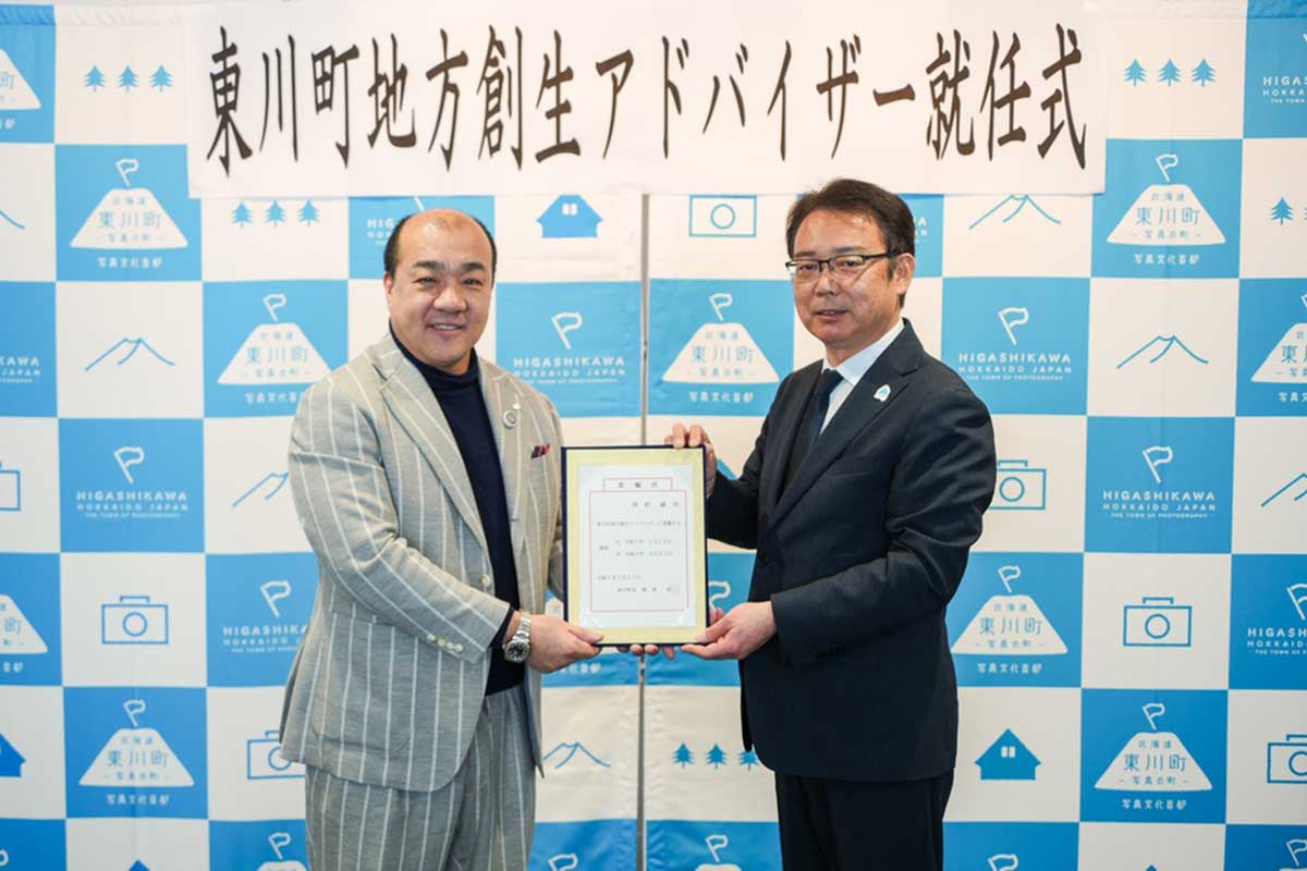 東川町の地方創生アドバイザー就任式で証書を菊地伸町長から手渡される西村誠司氏【写真：東川町提供】